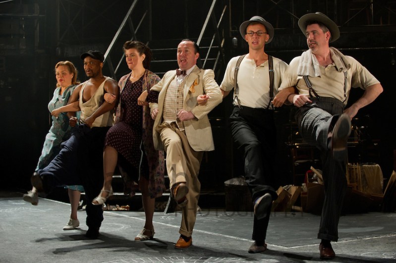 London, UK. 16/09/2011. "Street Scene" by Kurt Weill (music) and Elmer Rice (book) returns to The Young Vic, London. 24 hours in the life of a 1940's New York City tenement on a hot summer's day with an eighty-strong cast, full choir and orchestra. L to R: Simone Suaphanor (as Mrs Fiorentino), John Moabi (as Dick McGann), Harriet Williams (as Mrs Olsen), Joseph Shovelton (as Lippo Fiorentino), James McOran-Campbell (as Mr Easter) and Paul Reeves (as Mr Olsen). Photo credit: Jane Hobson